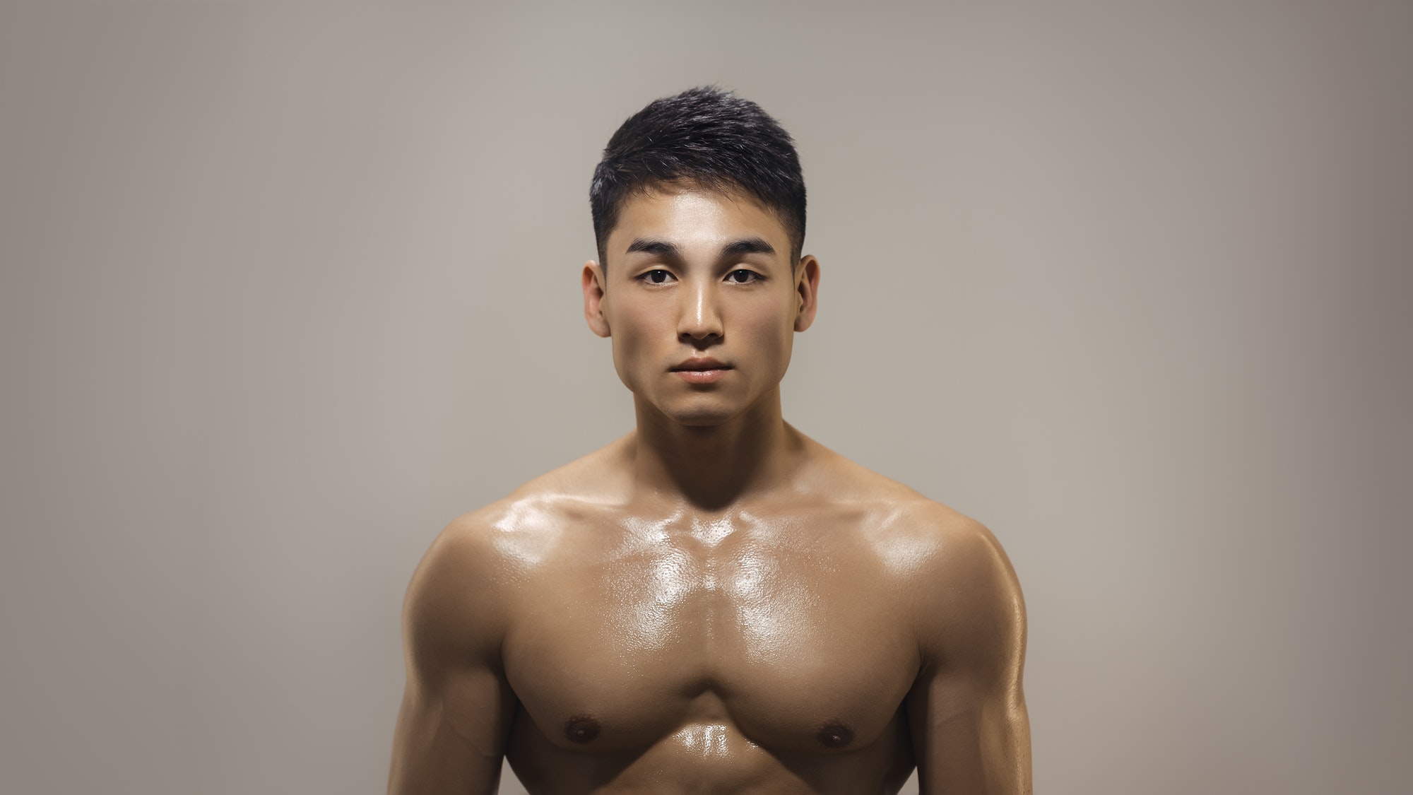 Muscular Asian Man Indoors in the Studio